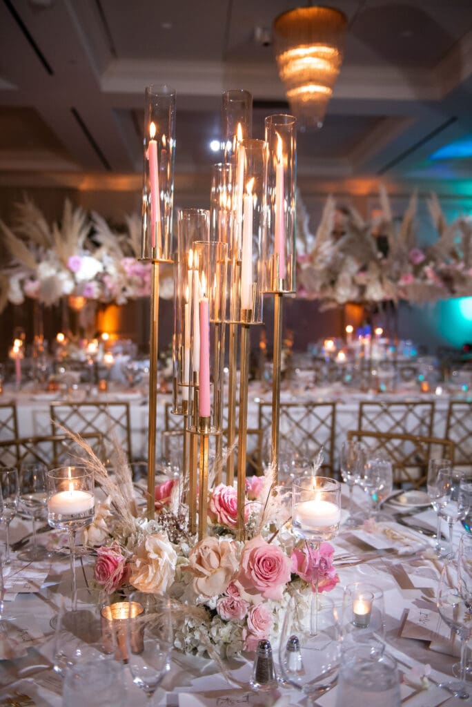 Boho-inspired wedding detail with tall bridal sandals and floral arrangement on table at Pelican Club Jupiter