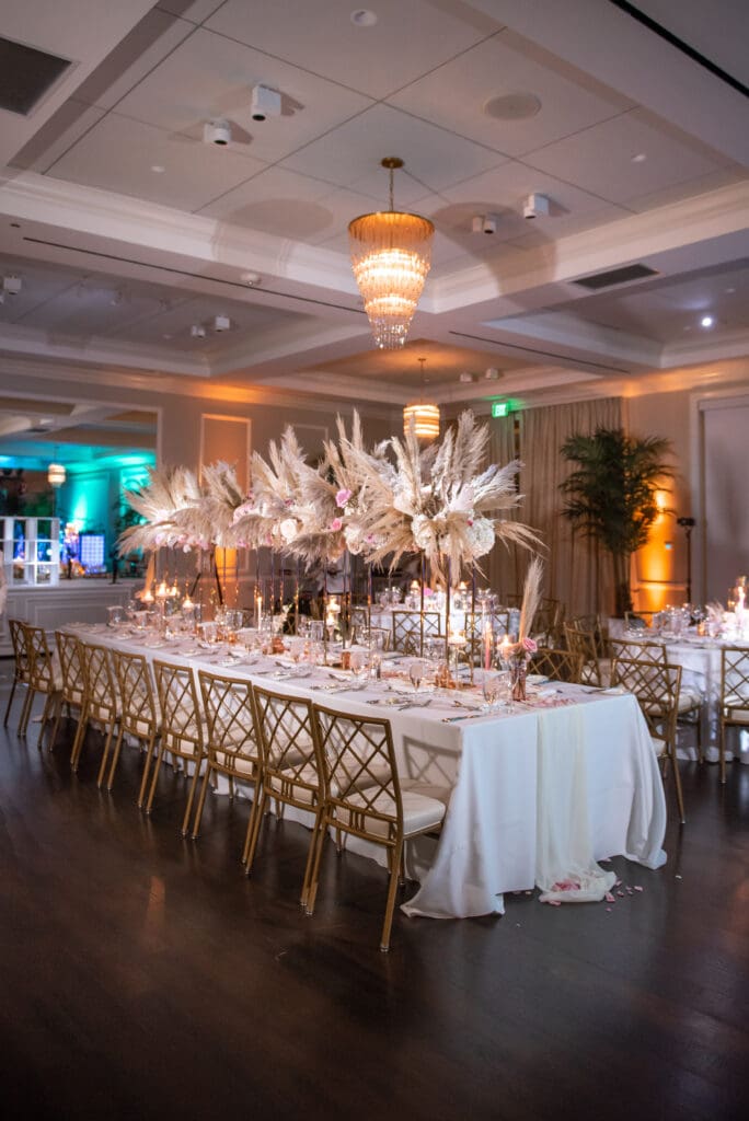Boho-style wedding table display featuring flowers and feathers at Pelican Club Jupiter venue