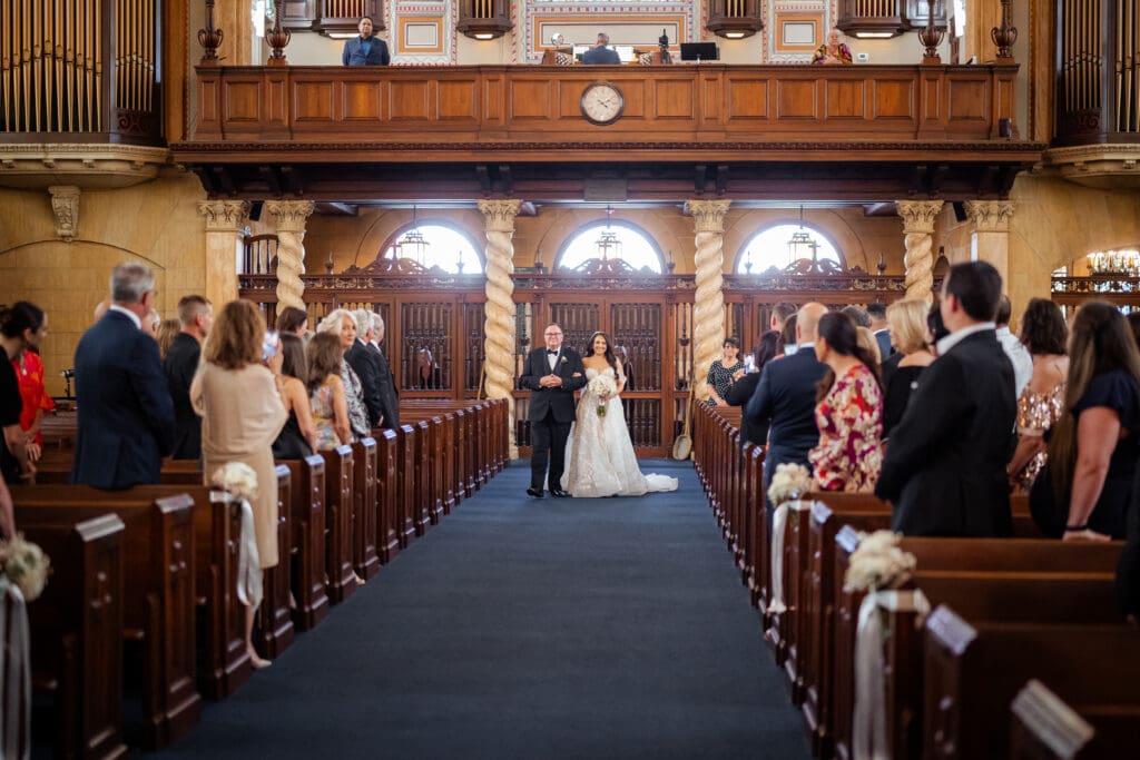 Bride walking down the aisle at Bethesda-by-the-Sea in Palm Beach
